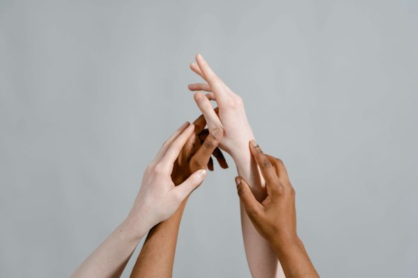 Hands with different skin tones, illustrating how skin tone affects flattering clothing color choices