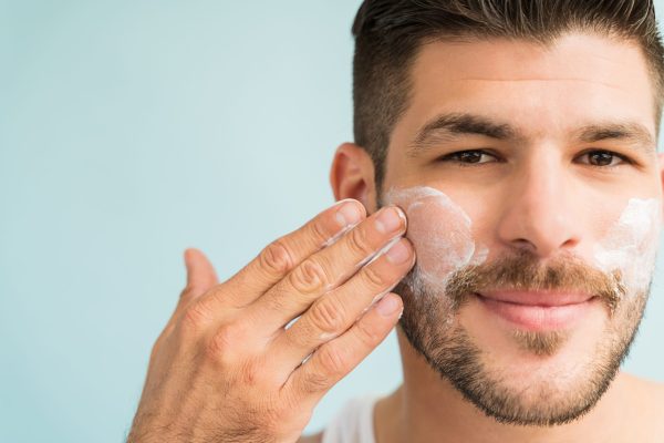 Man applying face cream, illustrating the skin cycling skincare routine