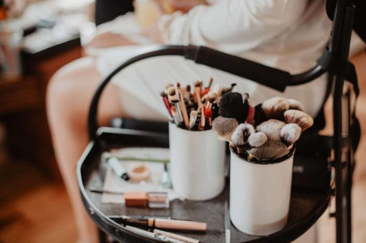 Makeup brushes and beauty tools organized on a trolley, representing proper makeup tool care