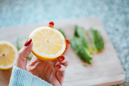 Hand holding a lemon, illustrating natural remedies for dull and tired-looking skin