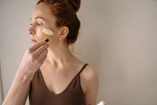 Woman using a facial roller for facial massage
