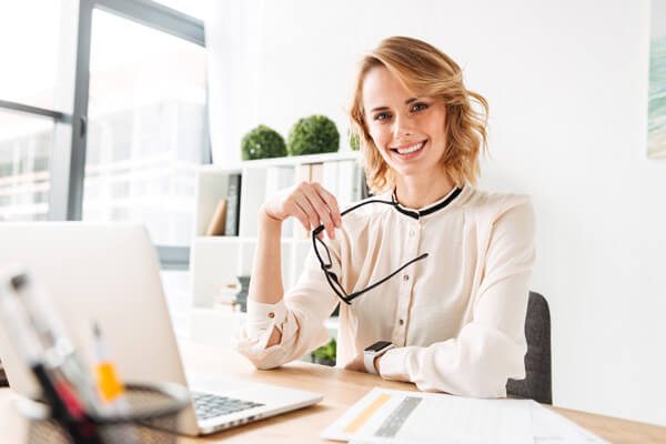 Woman at a desk during an interview about the creation of Regene Supreme skincare for smokers