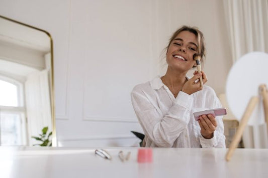 Woman applying complexion makeup, comparing BB cream, CC cream and foundation