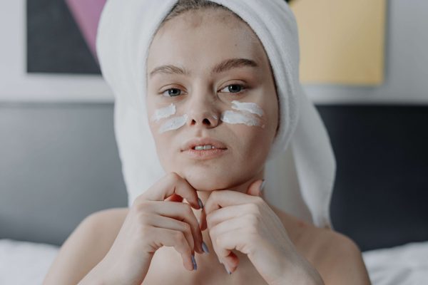 Woman applying facial cream, illustrating how to choose the right face cream for your skin